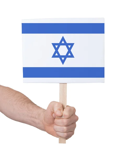 Hand met kleine kaartje - vlag van Israël — Stockfoto