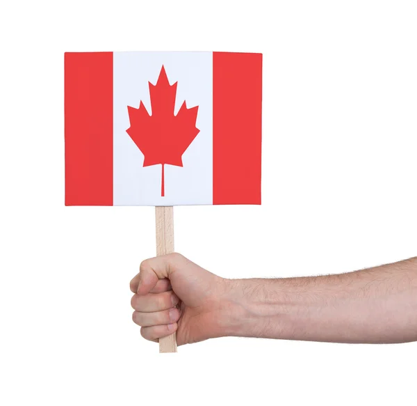 Mano sosteniendo una tarjeta pequeña - Bandera de Canadá —  Fotos de Stock