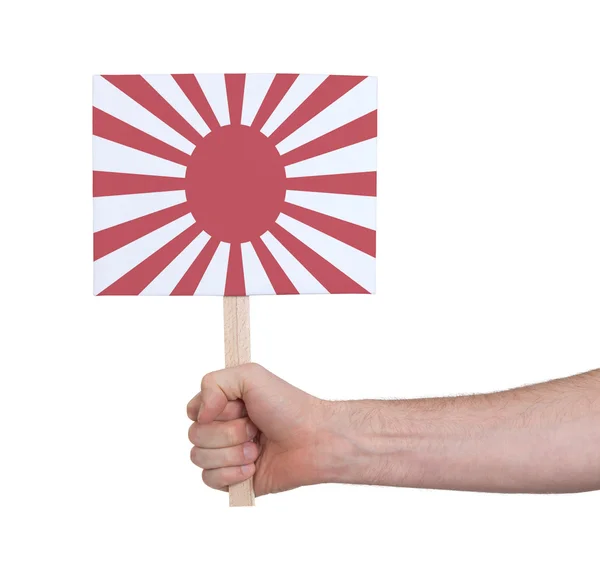 Hand hält kleine Karte - Flagge Japans — Stockfoto