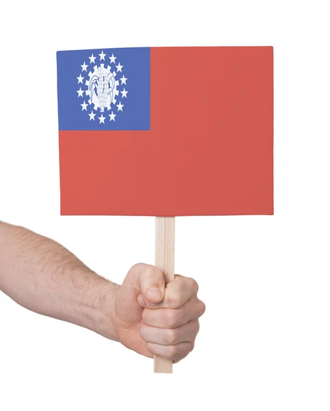 Hand met kleine kaartje - vlag van Myanmar — Stockfoto