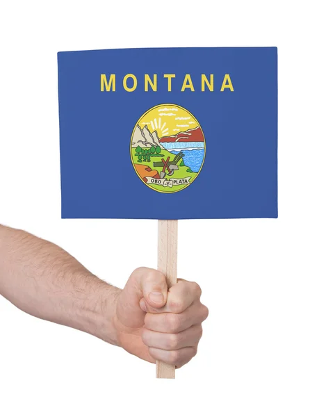 Hand holding small card - Flag of Montana — Stock Photo, Image