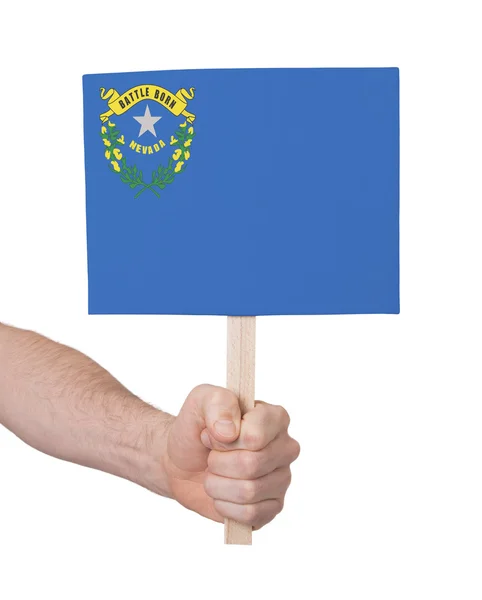 Hand met kleine kaartje - vlag van Nevada — Stockfoto