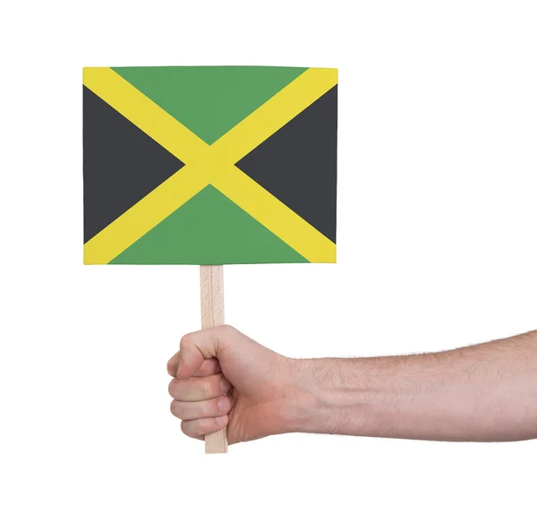 Hand holding small card - Flag of Jamaica — Stock Photo, Image