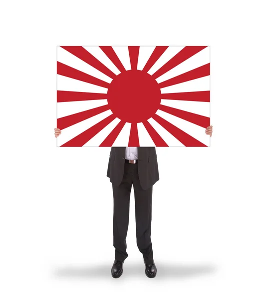 Smiling businessman holding a big card, flag of Japan — Stock Photo, Image