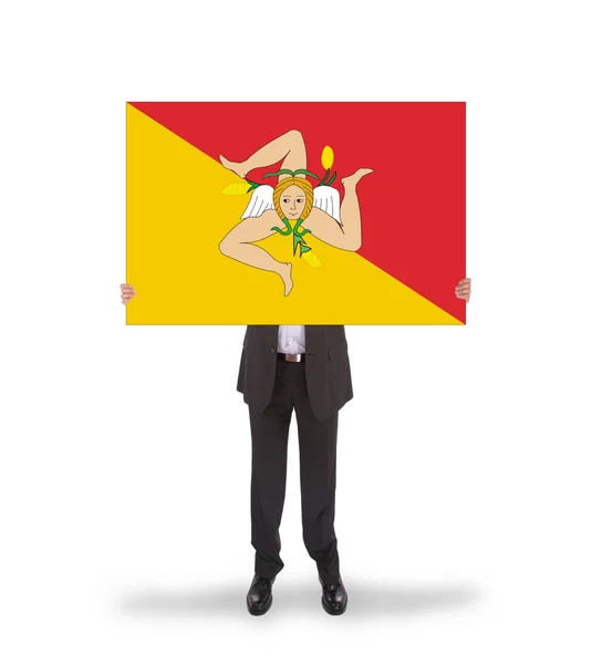 Smiling businessman holding a big card, flag of Sicily — Stock Photo, Image