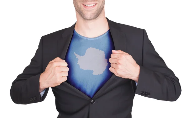 Businessman opening suit to reveal shirt with flag — Stock Photo, Image