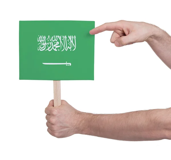 Mano sosteniendo tarjeta pequeña - Bandera de Arabia Saudita — Foto de Stock