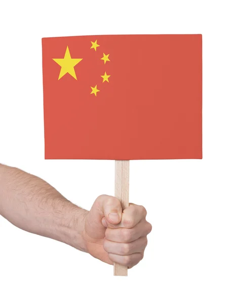 Hand hält kleine Karte - Flagge aus China — Stockfoto