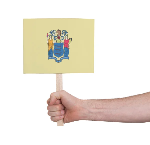 Hand holding small card - Flag of New Jersey — Stock Photo, Image