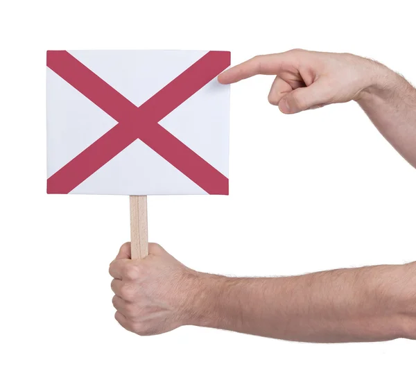 Mano sosteniendo una tarjeta pequeña - Bandera de Alabama —  Fotos de Stock