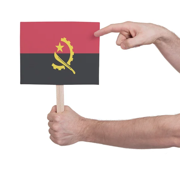 Hand met kleine kaartje - vlag van Angola — Stockfoto