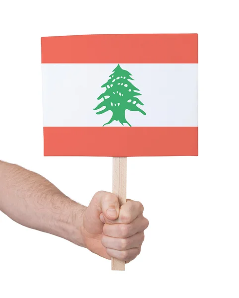 Hand holding small card - Flag of Lebanon — Stock Photo, Image