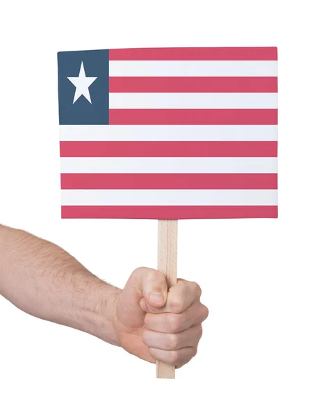 Ręka gospodarstwa małe karty - flaga Liberii — Zdjęcie stockowe