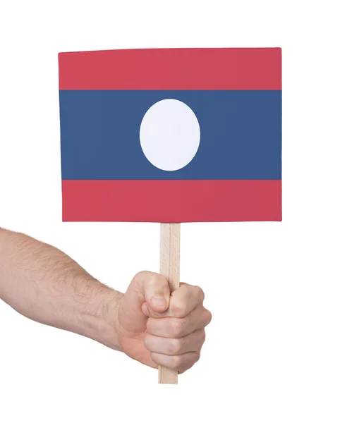 Ruka držící malé karty - vlajka Laosu — Stock fotografie