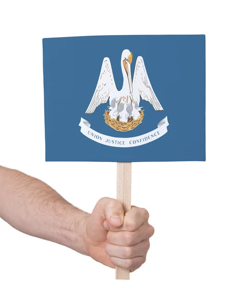 Hand som håller litet kort - flagga i Louisiana — Stockfoto