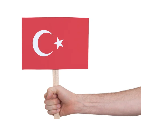 Руки, що тримає невелика картка - прапор Туреччини — стокове фото
