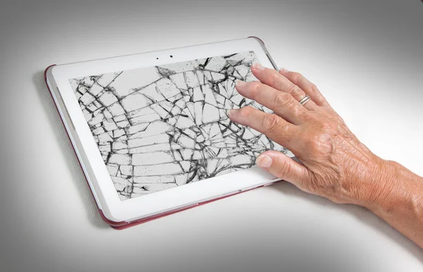 Senior lady with tablet, cracked screen — Stock Photo, Image