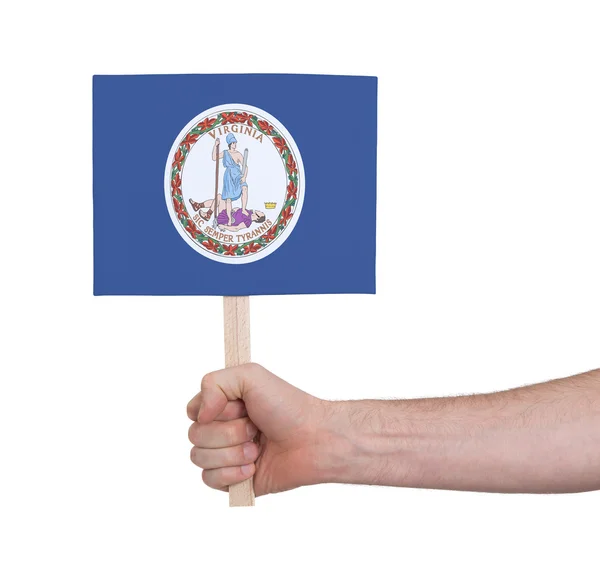Mano sosteniendo una tarjeta pequeña - Bandera de Virginia —  Fotos de Stock