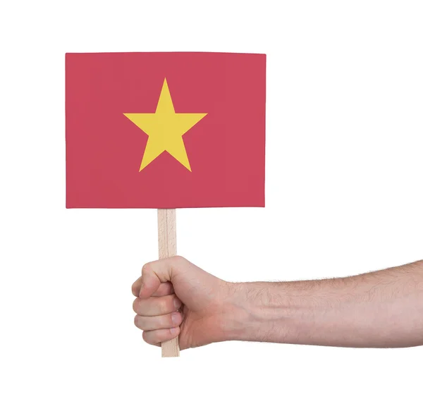 Mão segurando cartão pequeno - Bandeira do Vietnã — Fotografia de Stock