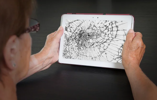 Senior lady with tablet, cracked screen