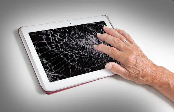 Senior lady with tablet, cracked screen — Stock Photo, Image