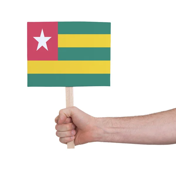 Mano che tiene piccola carta - Bandiera del Togo — Foto Stock