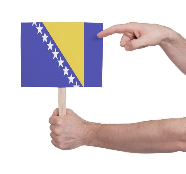 Hand met kleine kaartje - vlag van Bosnië Herzegovina — Stockfoto