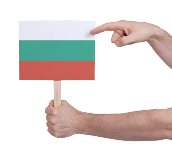 Mano sosteniendo una tarjeta pequeña - Bandera de Bulgaria —  Fotos de Stock