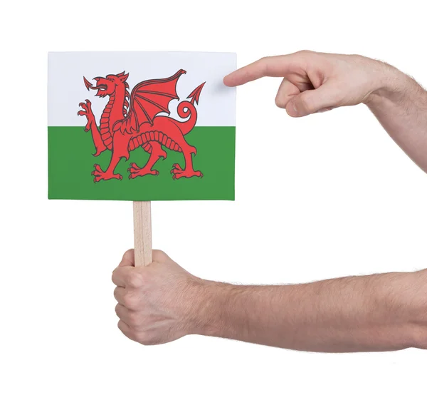 Hand hält kleine Karte - Fahne von Wales — Stockfoto