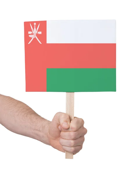 Main tenant une petite carte - Drapeau d'Oman — Photo