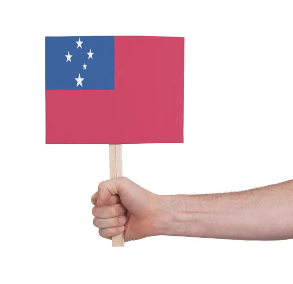 Руки, що тримає невелика картка - прапор Самоа — стокове фото