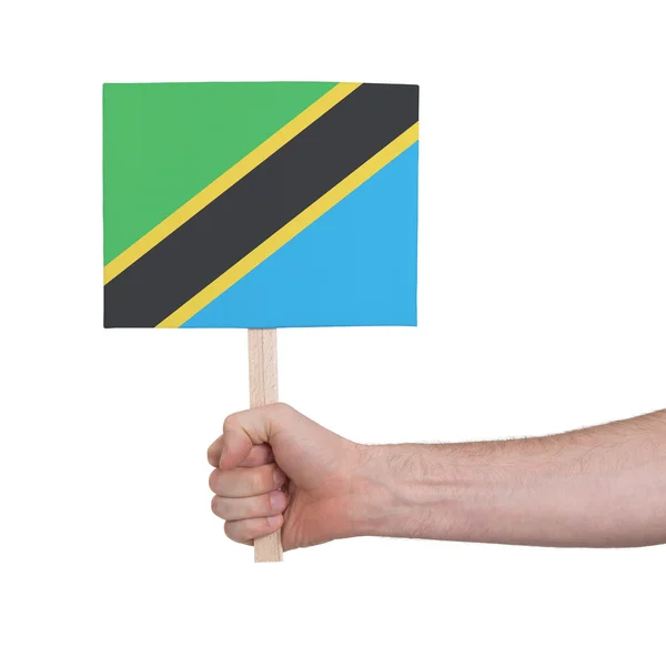 Main tenant une petite carte - Drapeau de Tanzanie — Photo