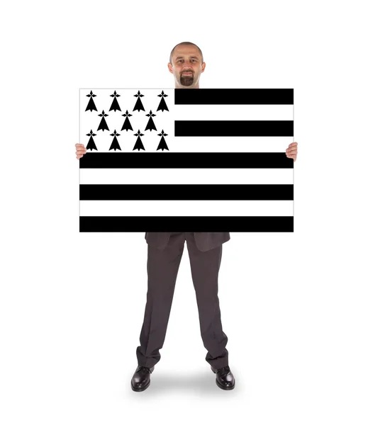 Leende affärsman håller ett stort kort, flagga Bretagne — Stockfoto