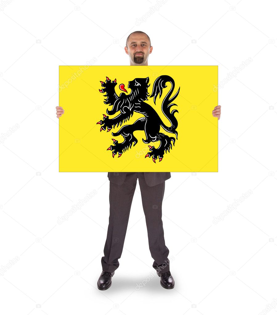 Smiling businessman holding a big card, flag of Flanders