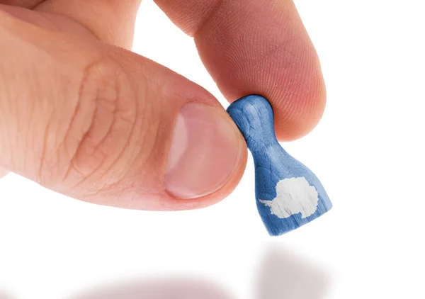 Hand holding wooden pawn, flag painting, selective focus — Stock Photo, Image