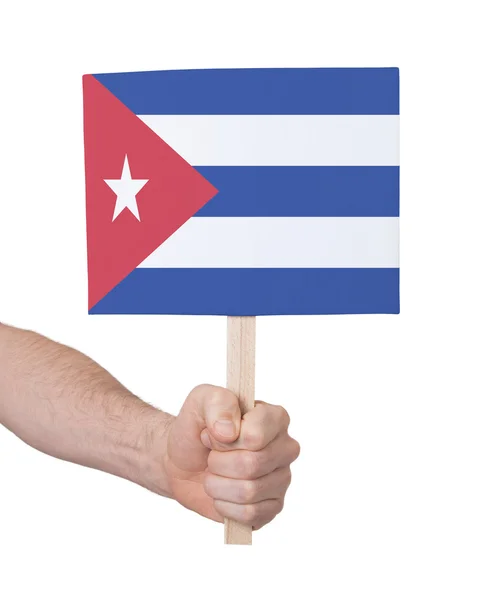 Hand som håller litet kort - flaggan på Kuba — Stockfoto