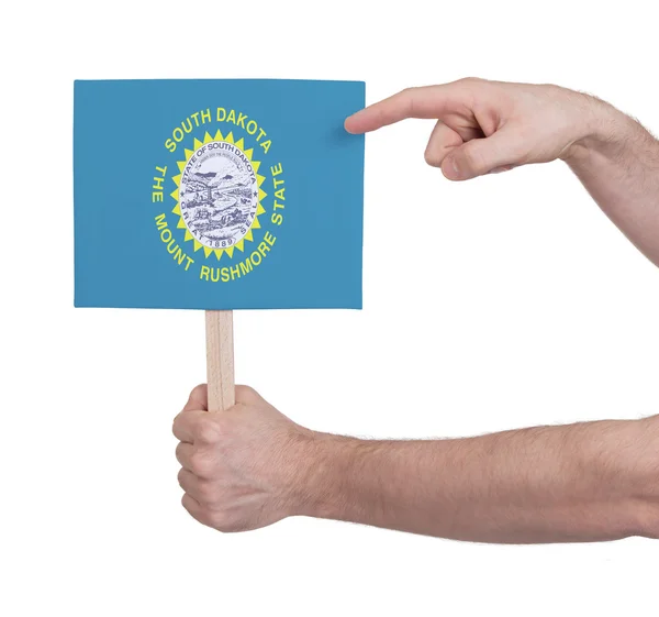 Mano sosteniendo una tarjeta pequeña - Bandera de Dakota del Sur — Foto de Stock