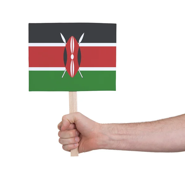 Hand holding small card - Flag of Kenya — Stock Photo, Image