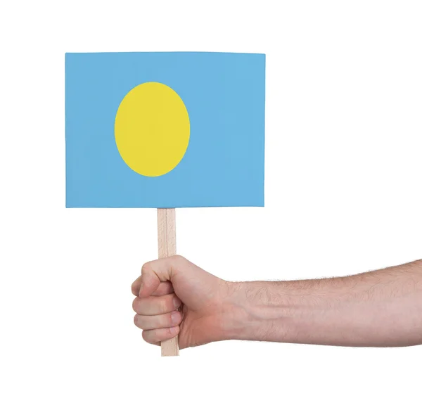 Hand holding small card - Flag of Palau — Stock Photo, Image