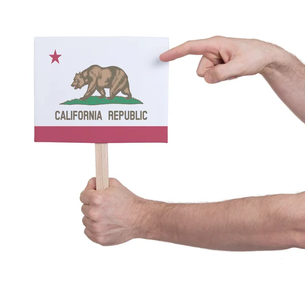 Mano sosteniendo una tarjeta pequeña - Bandera de California — Foto de Stock