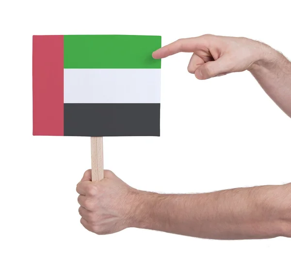 Mano sosteniendo una tarjeta pequeña - Bandera de Sudán — Foto de Stock