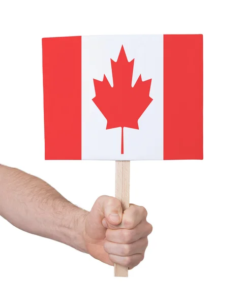 Mano sosteniendo una tarjeta pequeña - Bandera de Canadá —  Fotos de Stock