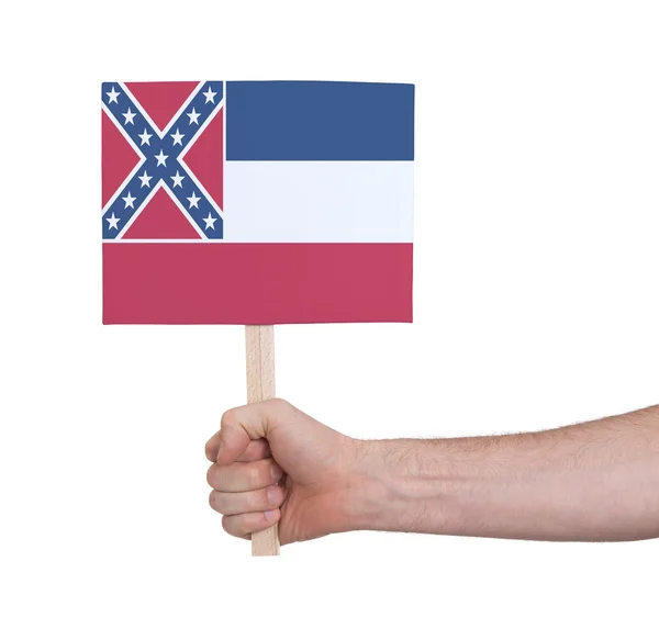 Mão segurando cartão pequeno - Bandeira do Mississippi — Fotografia de Stock