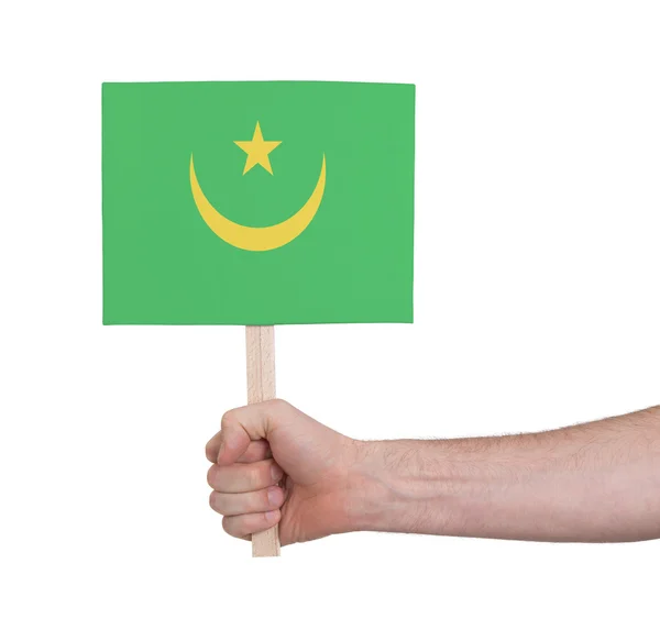 Mão segurando cartão pequeno - Bandeira da Mauritânia — Fotografia de Stock