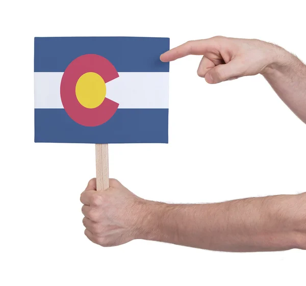 Mano sosteniendo una tarjeta pequeña - Bandera de Colorado — Foto de Stock