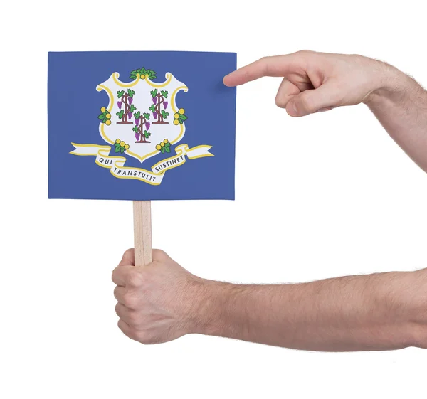 小さなカード - コネチカット州の旗を持っている手 — ストック写真