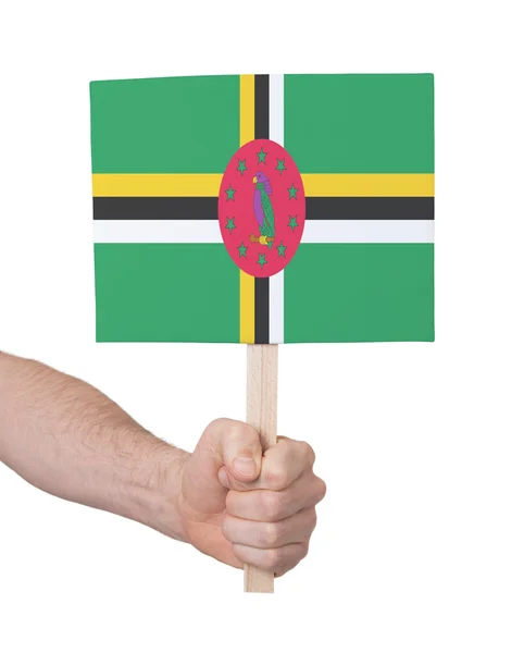 Ręka gospodarstwa małe karty - flaga Dominiki — Zdjęcie stockowe