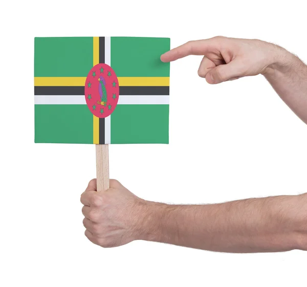 Hand met kleine kaartje - vlag van Dominica — Stockfoto