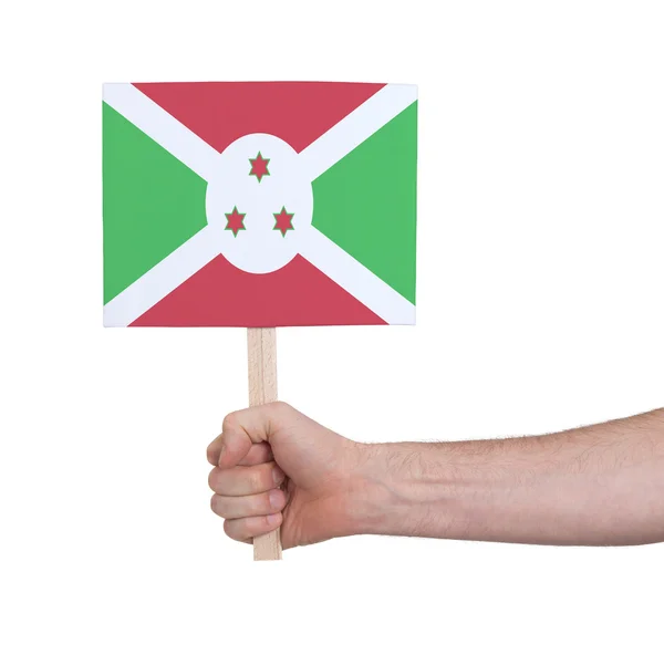 Mano sosteniendo una tarjeta pequeña - Bandera de Burundi — Foto de Stock