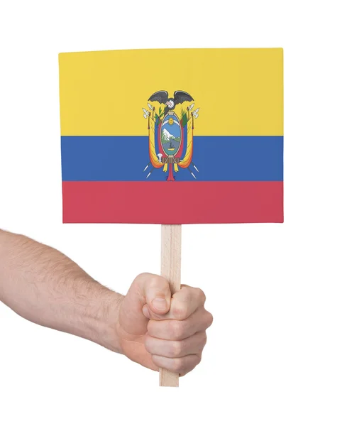 Χέρι που κρατά μικρή κάρτα - σημαία του Ισημερινού — Φωτογραφία Αρχείου